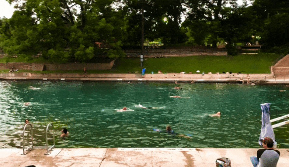 A group of peoplw swimming in Barton Springs Pool