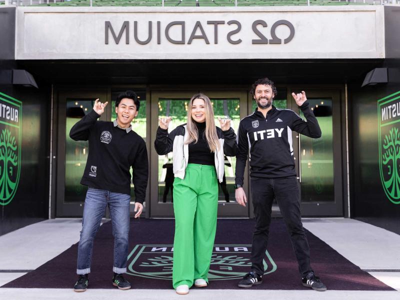 Tony Ho, Alfredo Naim and Emely Alvarado stand together outside of Q2 Stadium in Austin, Texas